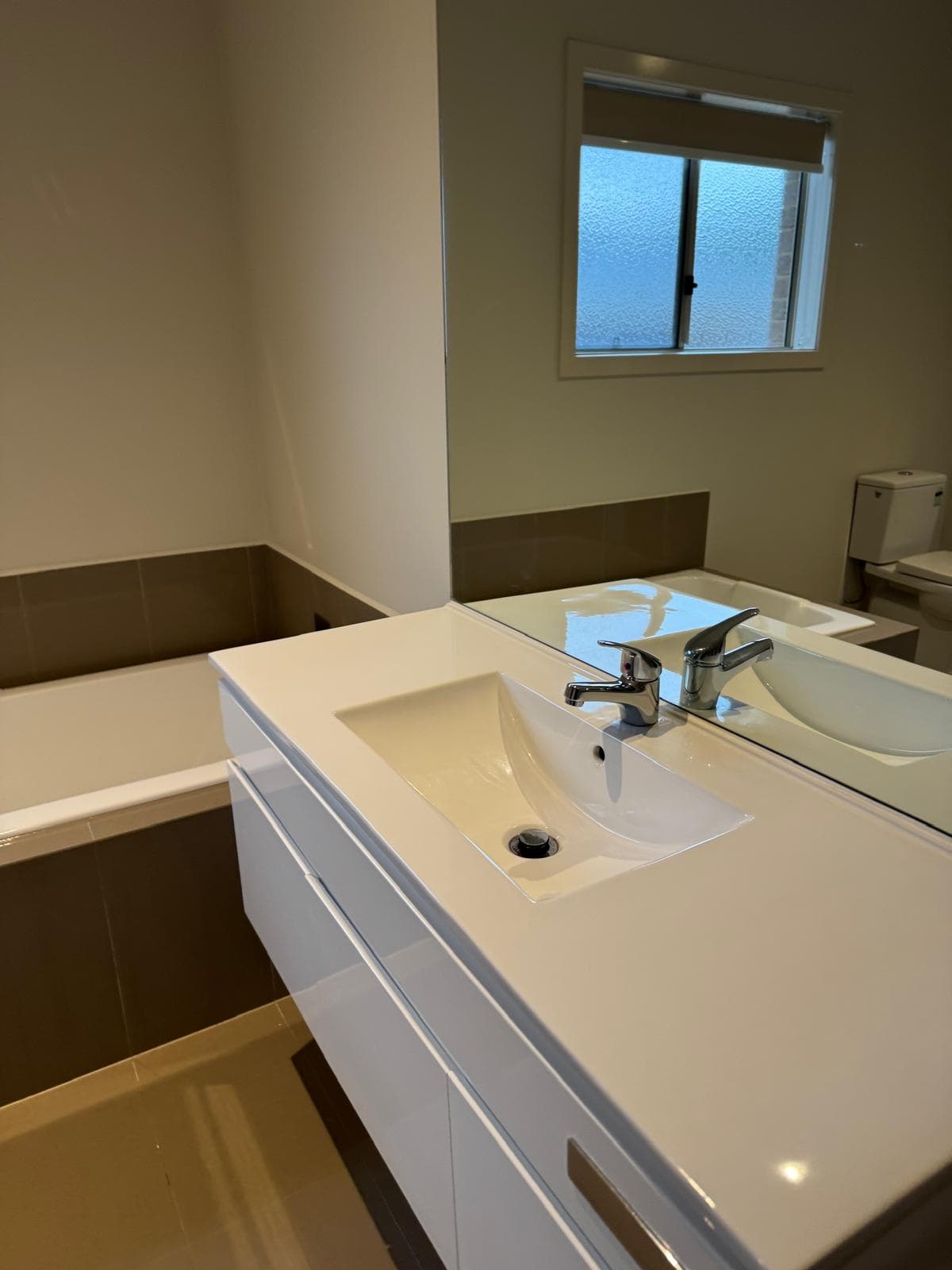 Kitchen cleaned for handover — benches, sink and splashbacks