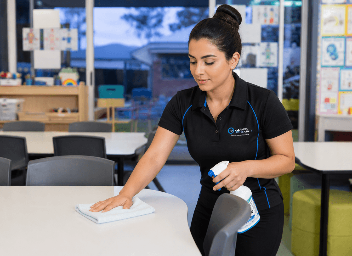 Professional childcare cleaner sanitising tables and surfaces with child-safe products in Melbourne